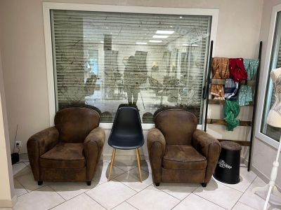 three chairs and a chair in a room with a large window