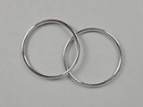 two silver rings on a white surface with a white background