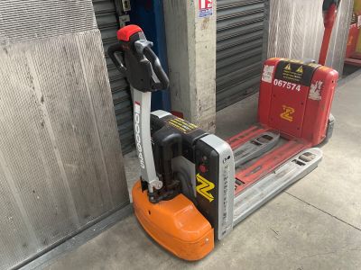 a forklift that is sitting next to a parking meter