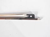 two chopsticks on a white surface with a black handle