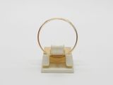 a close up of a ring on a stand with a white background