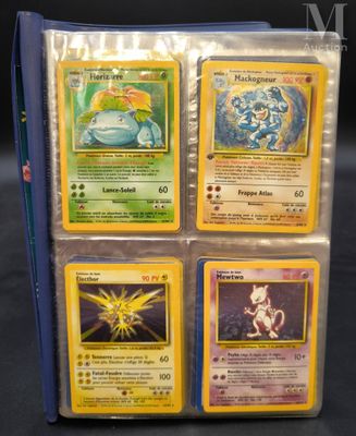 four pokemon cards are in a blue case on a table