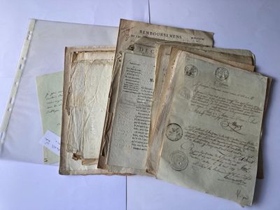 quelques vieux papiers sont posés sur une table blanche