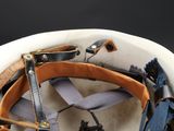 a close up of a helmet with a leather strap on it
