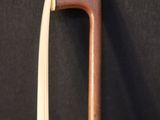 a close up of a cane with a wooden handle on a black background