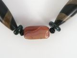a picture of a necklace with two wooden beads on it