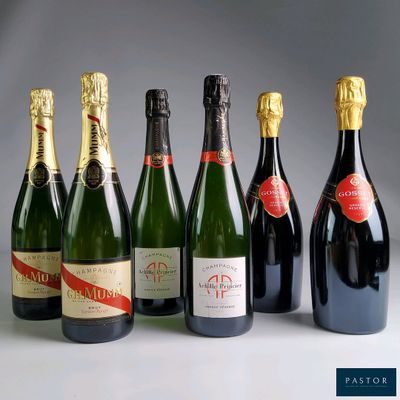 six bottles of champagne are lined up in a row on a table