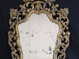 an ornately decorated mirror on a black background with a black background