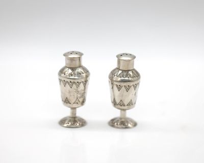 pair of silver salt and pepper shakers on a white background