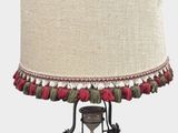a lamp that is sitting on a stand with a lamp shade on it