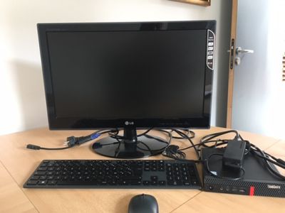 a computer monitor, keyboard, mouse and mouse on a table