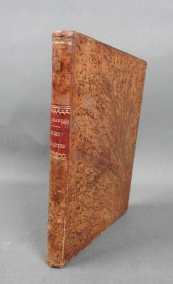 an old book sitting on top of a table next to a gray background