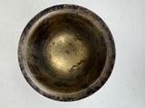 a close up of a metal bowl on a white surface