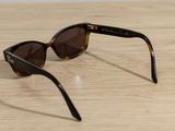 a pair of sunglasses sitting on a wooden table