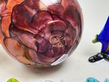 a glass vase and a figurine sitting on a table