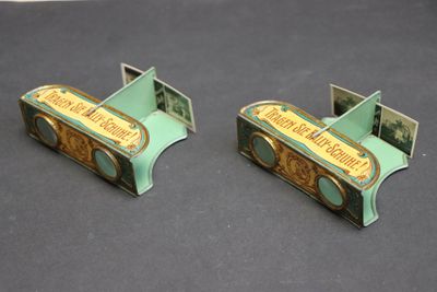 pair of green and gold bookends with a picture of a piano