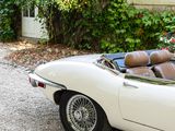 a white convertible car parked in front of a house