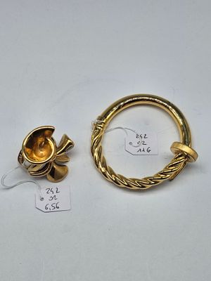 two gold rings and a ring with a flower on it