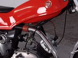 a red motorcycle that is parked in a garage