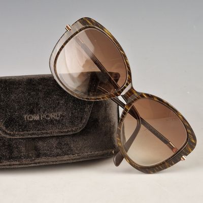 sunglasses in a case on a white surface with a gray background