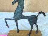 statue of a horse on a wooden base on a table