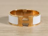 a close up of a white and gold ring on a wooden surface