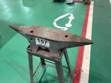 a small metal anvil on a stand in a room