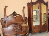 several pieces of furniture including a bed, dresser, and mirror
