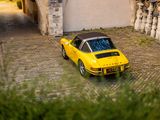 a yellow car that is parked in front of a building