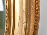 a close up of a mirror with a gold frame
