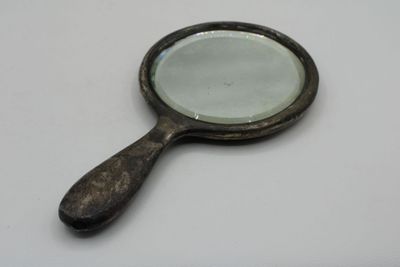 a small magnifying mirror sitting on a table