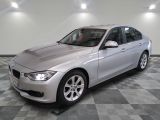 a picture of a silver bmw car in a showroom