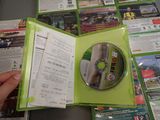a person holding a green case with a cd inside of it