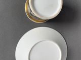 a white cup and saucer sitting on a table
