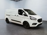 the white van is parked in a large room in a building