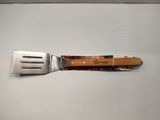a fork with a wooden handle on a white surface