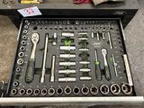 many tools in a tool box on the floor