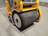 a large yellow machine that is parked in a parking lot