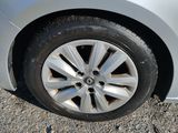 a silver car that is parked on the side of the road