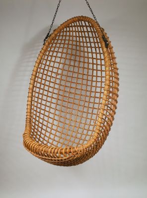 an image of a wicker hanging chair on a white wall