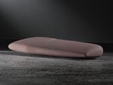 a pink pillow sitting on the floor in the dark