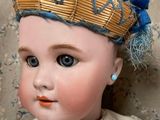 a small doll with a crown on it ' s head
