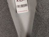 the label on a gray jacket is attached to a white shirt
