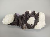 a piece of chocolate cake with white frosting on a plate