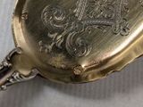 a close up of a pocket watch on a table