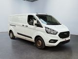 the white van is parked in the large room of the building