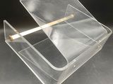 a clear box with a cigarette in it on a table
