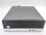 the back of a small computer with a keyboard on top of it