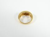 a close up of a gold ring on a white surface