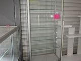 a glass display case in the corner of a room